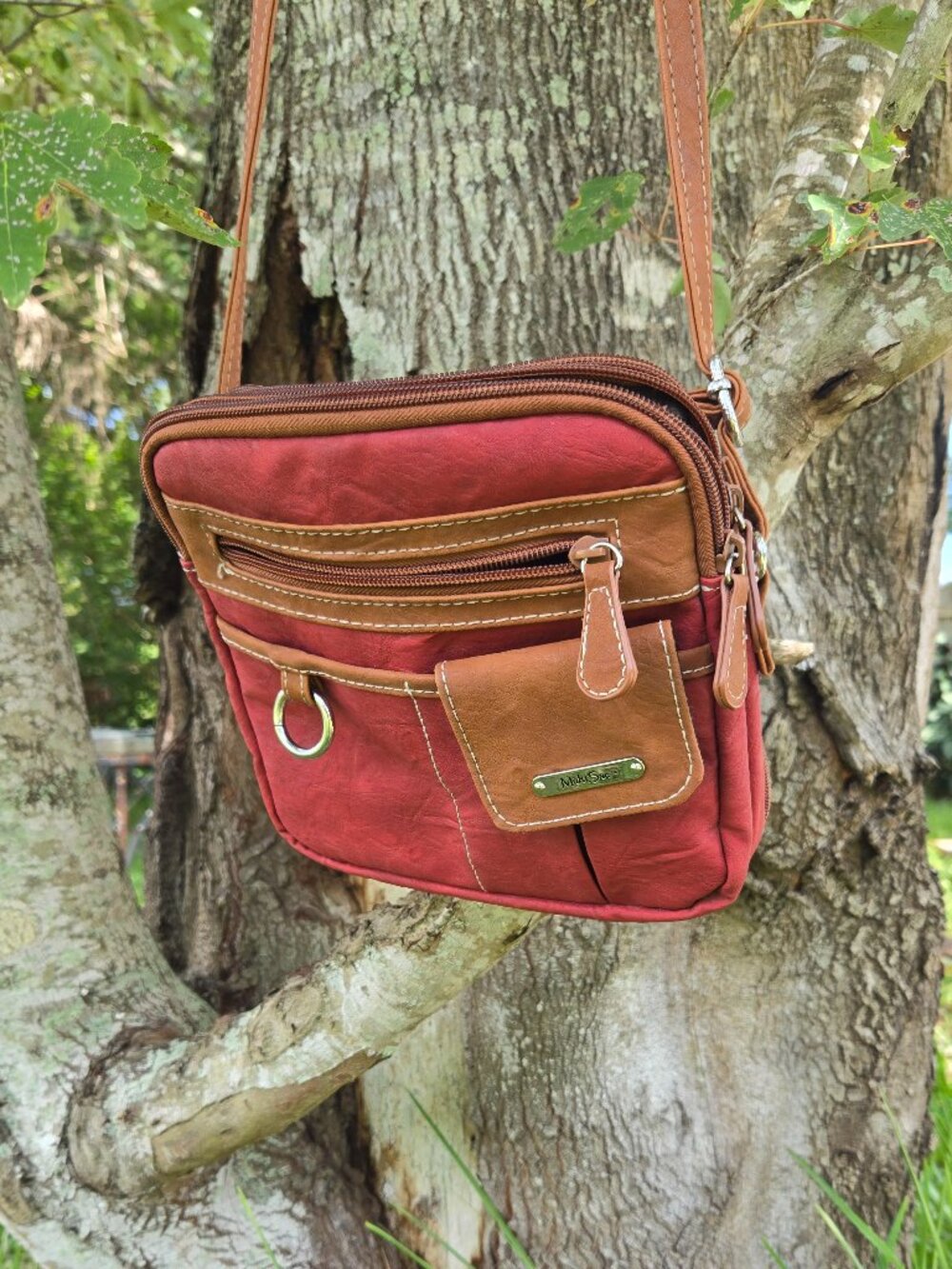 Dark Red Leather shoulder bag. With camel trim. Get organized with 8 pockets